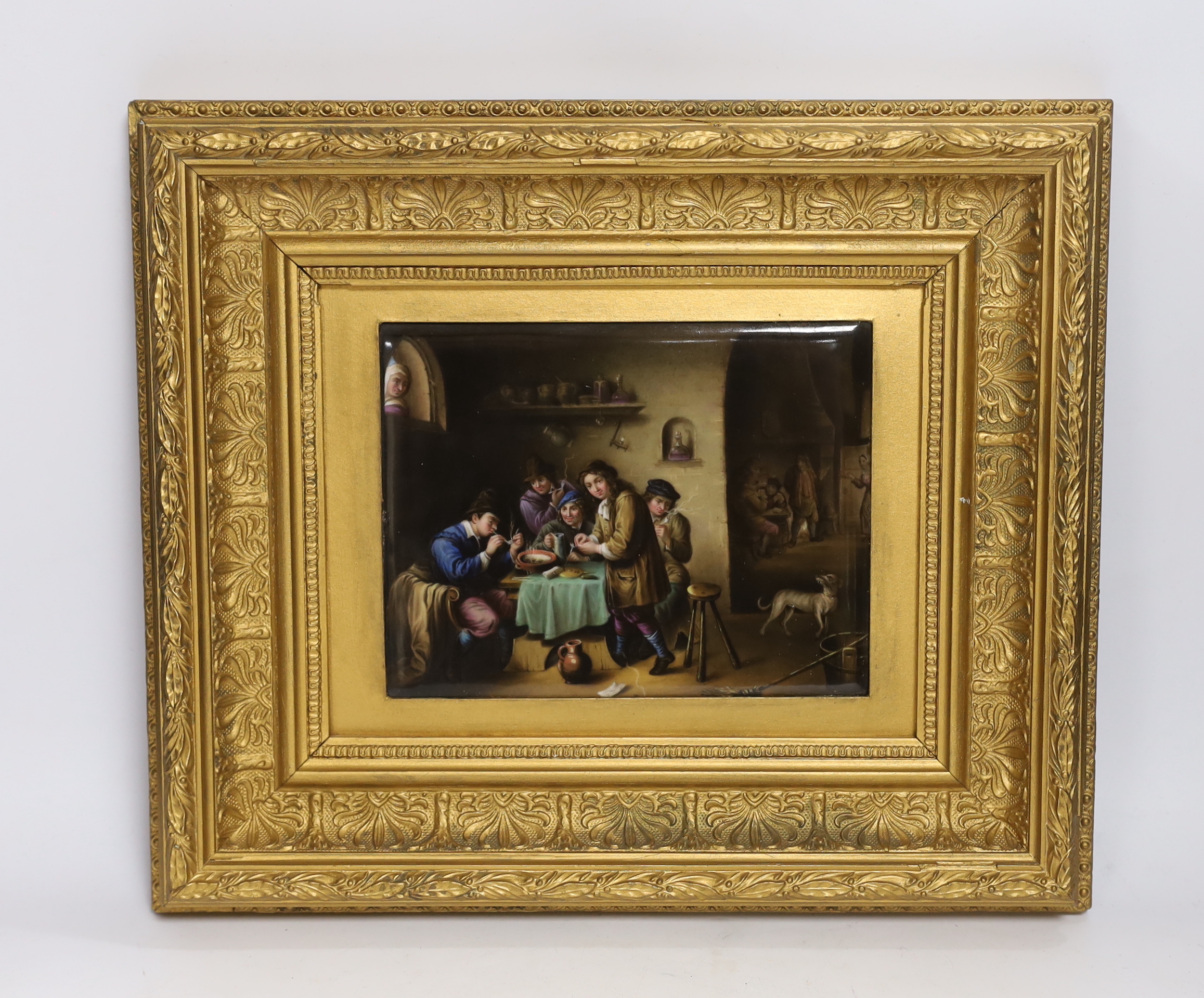 A Late 19th century porcelain plaque, painted with a tavern scene with figures, after Teniers, ornate gilt framed, 18 x 14cm